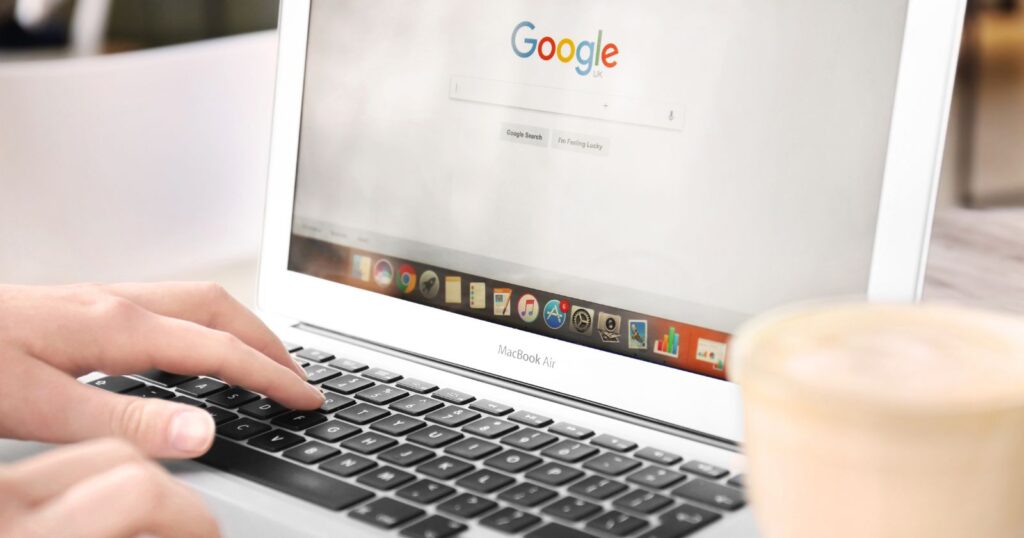 A laptop displaying a website with a search bar and the Google logo. Text reads "Optimizing your website for Google search: How to Use Google Trends Effectively