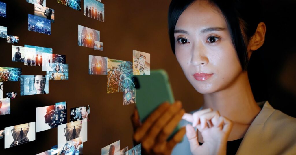 A woman holding a smartphone filled with numerous pictures, showcasing her expertise in elevating content game.