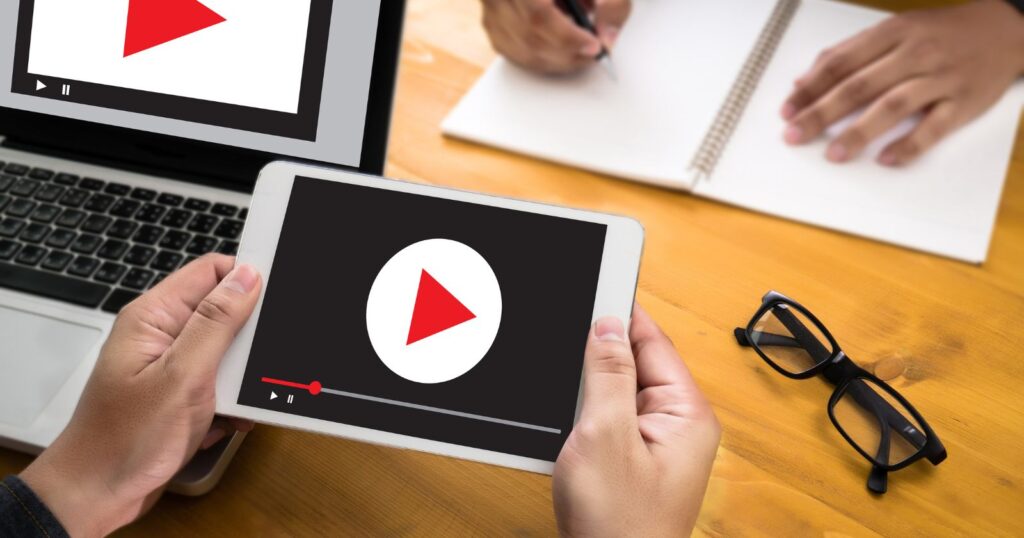 A thumbnail of a YouTube video showing a laptop with dollar signs on the screen, representing making money through YouTube videos.
