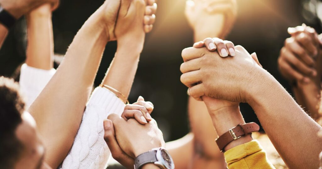 A diverse group of people standing together, symbolizing the importance of support systems in achieving success and overcoming challenges.